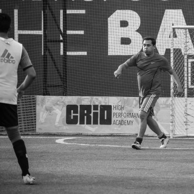 New Delhi, India - July 01 2018- Footballers of local football team during game in regional Derby championship on football pitch. Hot moment of football match on grass field stadium - Black and White