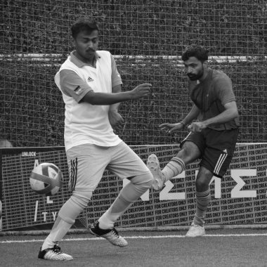 New Delhi, India - July 01 2018- Footballers of local football team during game in regional Derby championship on football pitch. Hot moment of football match on grass field stadium - Black and White