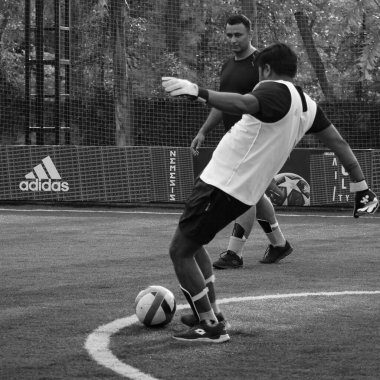 New Delhi, India - July 01 2018- Footballers of local football team during game in regional Derby championship on football pitch. Hot moment of football match on grass field stadium - Black and White
