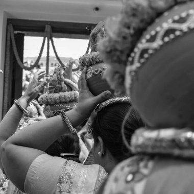 Women with Kalash on head during Jagannath Temple Mangal Kalash Yatra, Indian Hindu devotees carry earthen pots containing sacred water with coconut on top Black and White