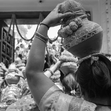 Women with Kalash on head during Jagannath Temple Mangal Kalash Yatra, Indian Hindu devotees carry earthen pots containing sacred water with coconut on top Black and White