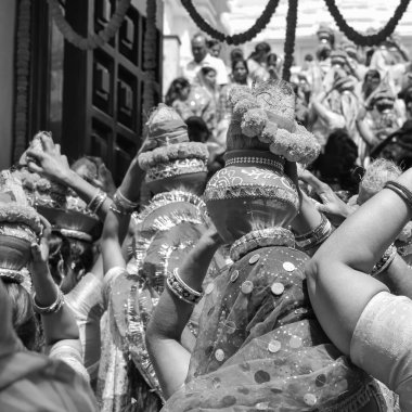 Women with Kalash on head during Jagannath Temple Mangal Kalash Yatra, Indian Hindu devotees carry earthen pots containing sacred water with coconut on top Black and White