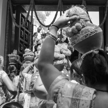 Women with Kalash on head during Jagannath Temple Mangal Kalash Yatra, Indian Hindu devotees carry earthen pots containing sacred water with coconut on top Black and White