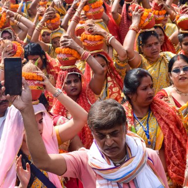 Yeni Delhi, Hindistan 3 Nisan 2022 - Jagannath Tapınağı sırasında Kalaşlı kadınlar Mangal Kalash Yatra, Hintli Hintli dindarlar üzerinde hindistan cevizi olan kutsal su dolu toprak kapları taşıyorlar