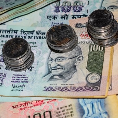 Rare Old Indian bank rupee coins falling on currency notes, Falling down Indian rupee coin on one hundred rupees notes, Indian Currency Coins falling