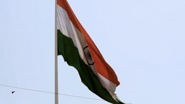 Slow-motion of India flag flying high at Connaught Place with pride in blue sky, India flag fluttering, Indian Flag on Independence Day and Republic Day of India, Waving Indian flag, Flying India flags