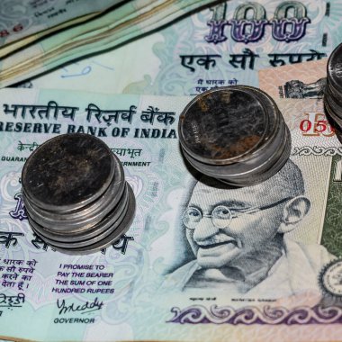 Rare Old Indian bank rupee coins falling on currency notes, Falling down Indian rupee coin on one hundred rupees notes, Indian Currency Coins falling