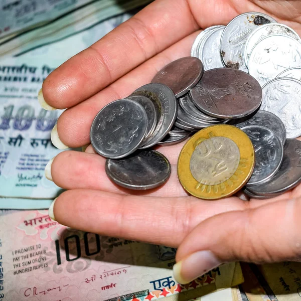 Rare Old Indian bank rupee coins falling on currency notes, Falling down Indian rupee coin on one hundred rupees notes, Indian Currency Coins falling