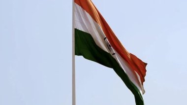 India flag flying high at Connaught Place with pride in blue sky, India flag fluttering, Indian Flag on Independence Day and Republic Day of India, tilt up shot, Waving Indian flag, Har Ghar Tiranga