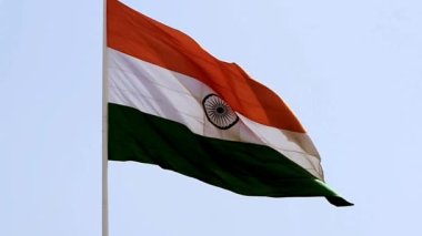 India flag flying high at Connaught Place with pride in blue sky, India flag fluttering, Indian Flag on Independence Day and Republic Day of India, tilt up shot, Waving Indian flag, Har Ghar Tiranga