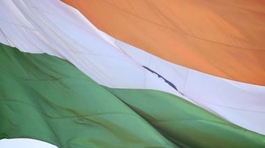 India flag flying high at Connaught Place with pride in blue sky, India flag fluttering, Indian Flag on Independence Day and Republic Day of India, tilt up shot, Waving Indian flag, Har Ghar Tiranga
