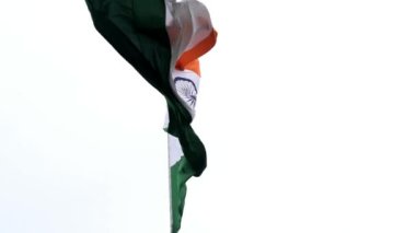 India flag flying high at Connaught Place with pride in blue sky, India flag fluttering, Indian Flag on Independence Day and Republic Day of India, tilt up shot, Waving Indian flag, Har Ghar Tiranga