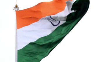 India flag flying high at Connaught Place with pride in blue sky, India flag fluttering, Indian Flag on Independence Day and Republic Day of India, tilt up shot, Waving Indian flag, Har Ghar Tiranga