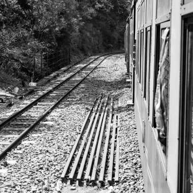 Oyuncak tren dağ yamacında, güzel bir manzara, bir dağ, bir vadi yeşil doğal ormanların arasında, tepeye giden demiryolu üzerinde hareket ediyor. Oyuncak tren Kalka 'dan Shimla' ya Hindistan-Siyah ve Beyaz