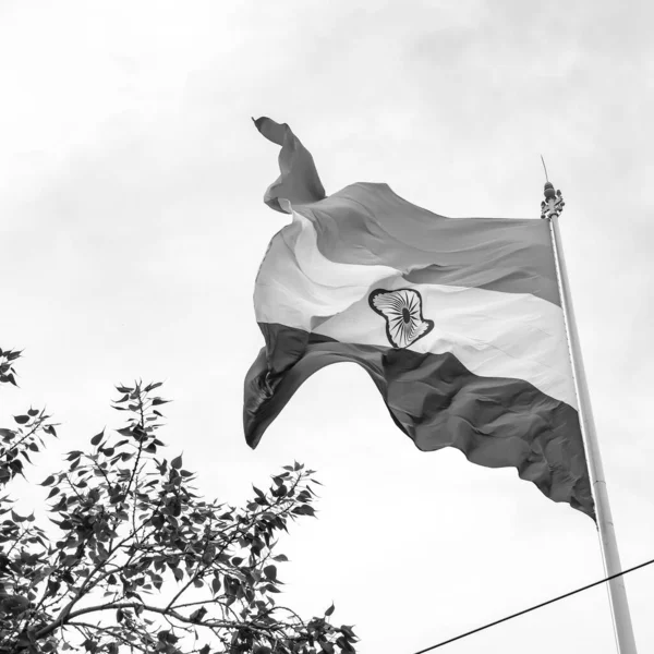 India flag flying at Connaught Place with pride in blue sky, India flag fluttering, Indian Flag on Independence Day and Republic Day of India, waving Indian flag, Flying India flags - Black and White