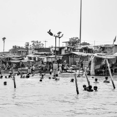 Garh Mukteshwar, UP, India, June 11 2022 -People are taking holy dip on the occasion of Nirjala Ekadashi, A view of Garh Ganga Brij ghat which is very famous religious place for Hindus-Black and White