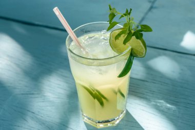 Caipirinha mavi ahşap bir masada limonla içer. Tipik Brezilya içkisi..