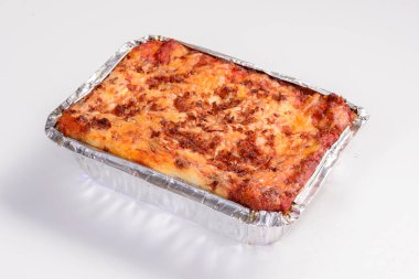 Lazanya teslimatı. Teslimat için paketlenmiş güneş eti lazanyası beyaz arkaplanda izole edilmiş..