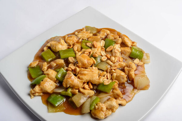 Chess chicken with green peppers, onions and peanuts in white plate isolated. Chinese traditional food. — Stock Image Chess Chicken Green Peppers Onions Peanuts White Plate Isolated Chinese Royalty Free Stock Photos