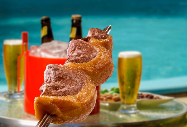 Brazilian Barbecue Picanha Skewers Blurred Beers Pool Background Royalty Free Stock Photos