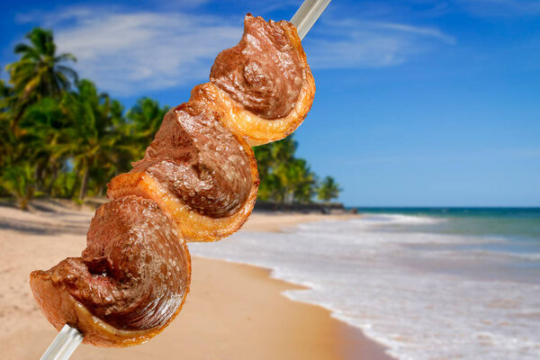 Barbecue picanha grilled on skewers with Brazilian beach scene in the background. — Stock Image Barbecue Picanha Grilled Skewers Brazilian Beach Scene Background Royalty Free Stock Images