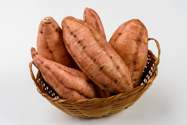 Sweet carrot potatoes in a basket isolated on white background. — Stock Image Sweet Carrot Potatoes Basket Isolated White Background Stock Image