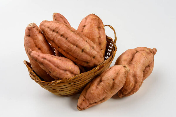 Sweet carrot potatoes in a basket isolated on white background. — Stock Image Sweet Carrot Potatoes Basket Isolated White Background Stock Photo