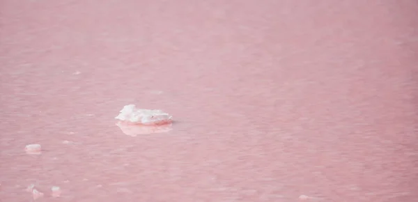Pink salt crystals. Natural pink salt lake texture. Salt mining. Extremely salty pink lake, colored by microalgae with crystalline salt depositions