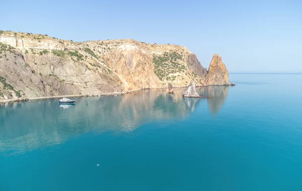 Aerial boat race. Luxury cruise trip. View from above of white boat on deep blue water. Aerial view of rich yacht sailing sea. Motor boat racing wave. Summer journey on luxury ship