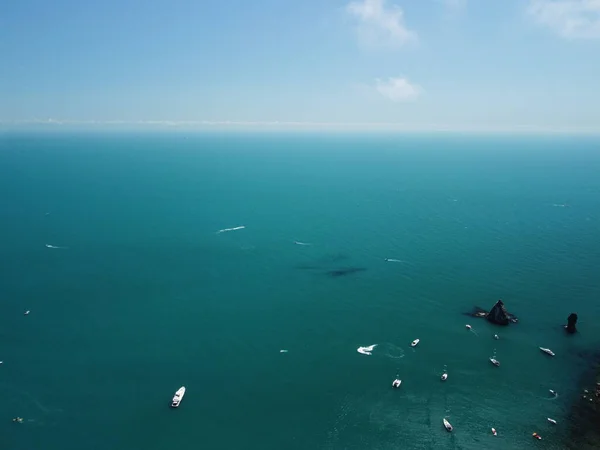 Aerial boat race. Luxury cruise trip. View from above of white boat on deep blue water. Aerial view of rich yacht sailing sea. Motor boat racing wave. Summer journey on luxury ship