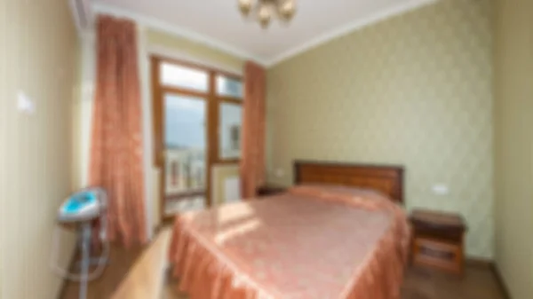 Master bedroom with wood bed and water view for background Abstract blur and defocused apartment, condominium, hotel, commercial building.