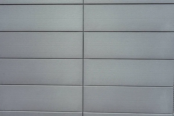 Oude grijze betonnen muur. Beton textuur, close-up. Achtergrond textuur van moderne grijze betonnen muur. Muur gemaakt van blokken. Textuur van gepleisterde kolommen. Fijne betonnen naadloze textuur. — Stockfoto