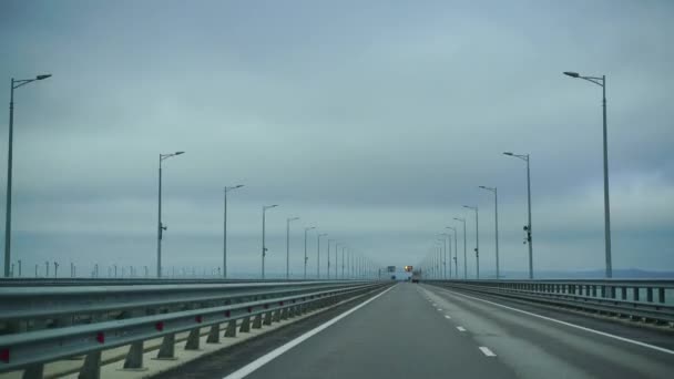 A car driving along a wide empty morning road early in the morning in cloudy weather. Driving point of view, inside view of a car on the Autobahn — Stock Video