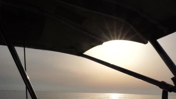 View from the yacht to the sunset at sea. Side view with green sea and waves. Concept, lifestyle and freedom. — Stock Video