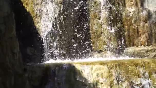 Waterfall in a Japanese garden, water slowly flows over large stones of volcanic origin — Stock Video
