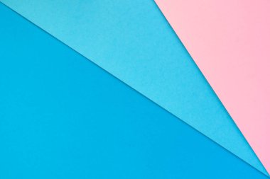 Pembe, mavi ve koyu mavi desenli kağıt arkaplan.