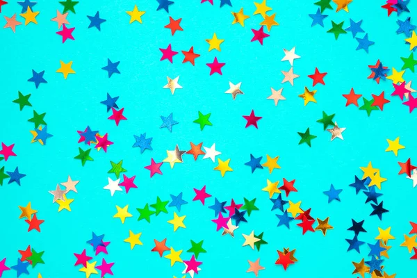 Multicolored stars on a blue paper background. — 图库照片
