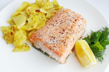 Baked salmon with potatoes, dill and lemon clipart