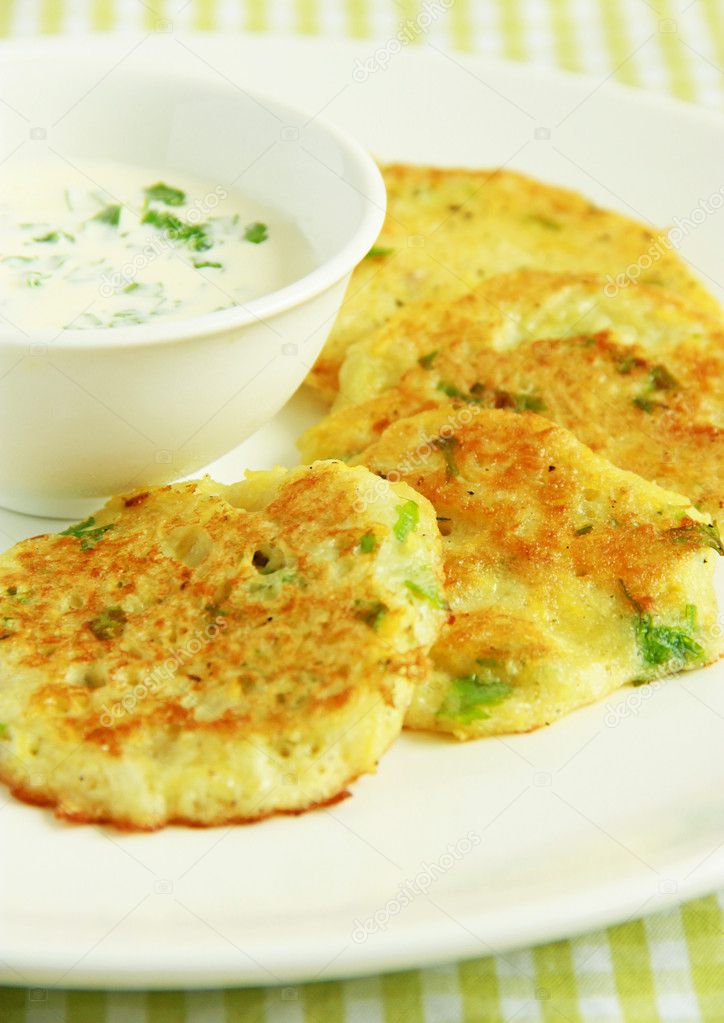 Potato pancakes with dill and sour cream sauce.