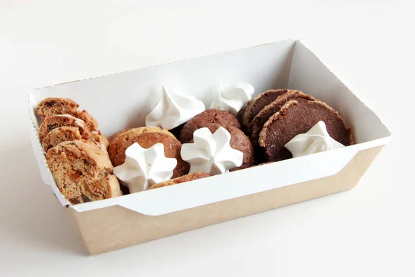 Assorted cookies on the plate. Fresh homemade cookies: biscotti, chocolate cookies, sugar cookies, meringe, nut cookies, caramel cookies, cocoa cookies