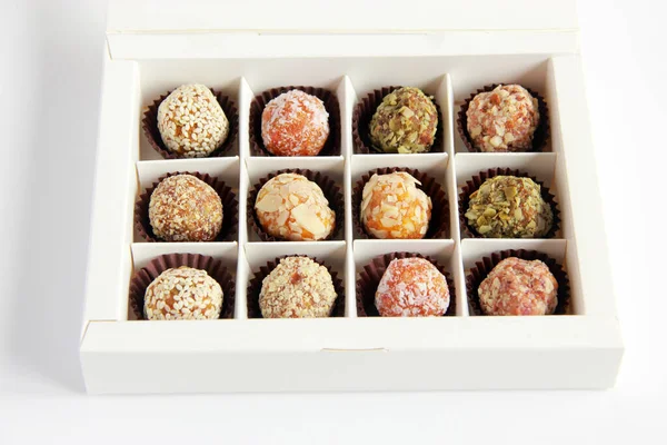 Homemade natural vegan sweets without sugar. Delicious sweets made of dry fruits and nuts in the box.