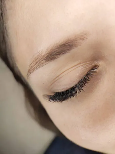 Lash extensions in beauty salon macro eye . High quality photo