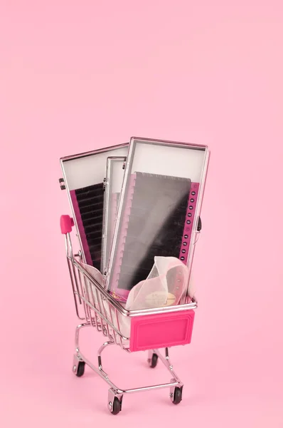 Equipment for eyelash extensions on pink background . High quality photo