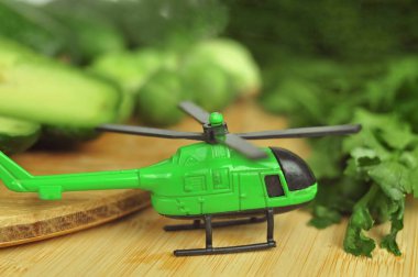 Green helicopter and vegetables import export of healthy food concept. High quality photo