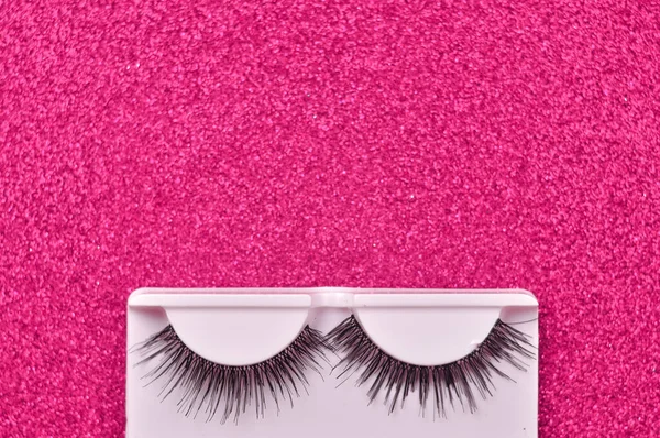 Pink background with false lashes copy space — Stock Photo, Image