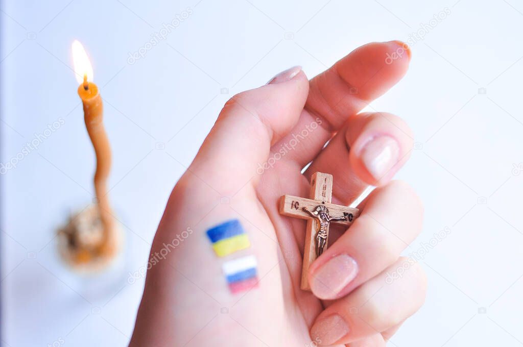 Orthodox Christ and drawned Russian and Ukrainian flags in hand. High quality photo