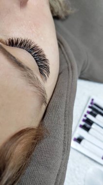 Eyelash extensions in beauty salon macro eye Kim effect 