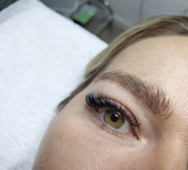 Eyelash extensions in beauty salon macro eye Kim effect 