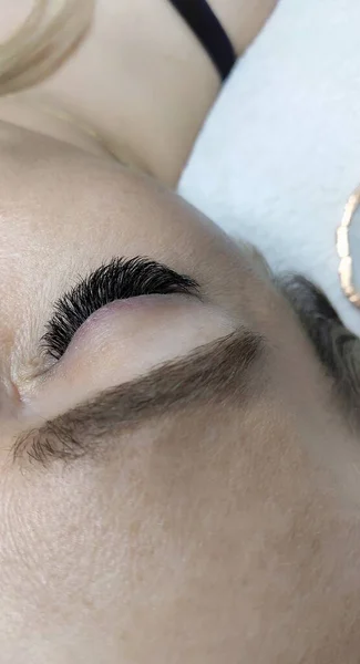 Eyelash extensions in beauty salon macro eye Kim effect