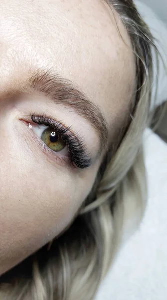 Eyelash extensions in beauty salon macro eye Kim effect